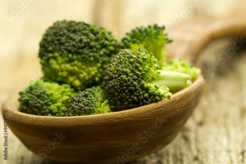 fresh broccoli in a spoon on wooden background. healthy food, vegetarian, slimming, diet.