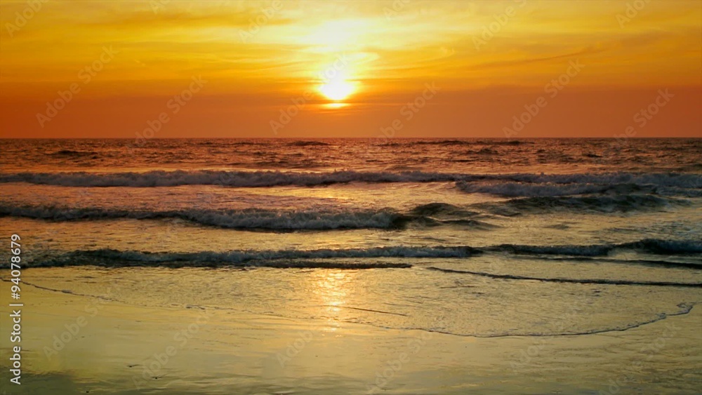 The sun is setting over the sea with gentle waves. The sun is setting over the sea with gentle waves.