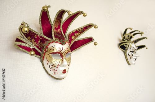 Masquerade masks hanging on white wall. Theater and opera. Carnival mask for Venetian festival. 