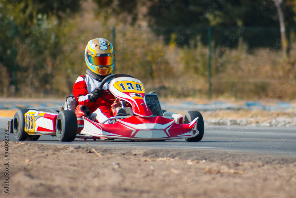 Karting - driver in helmet on kart circuit