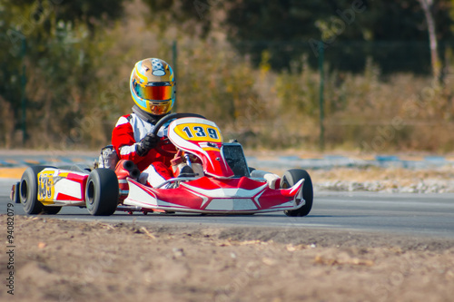 Karting - driver in helmet on kart circuit © master1305