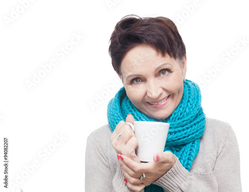 50 years old attractive woman with a white cup of tea in hand  i