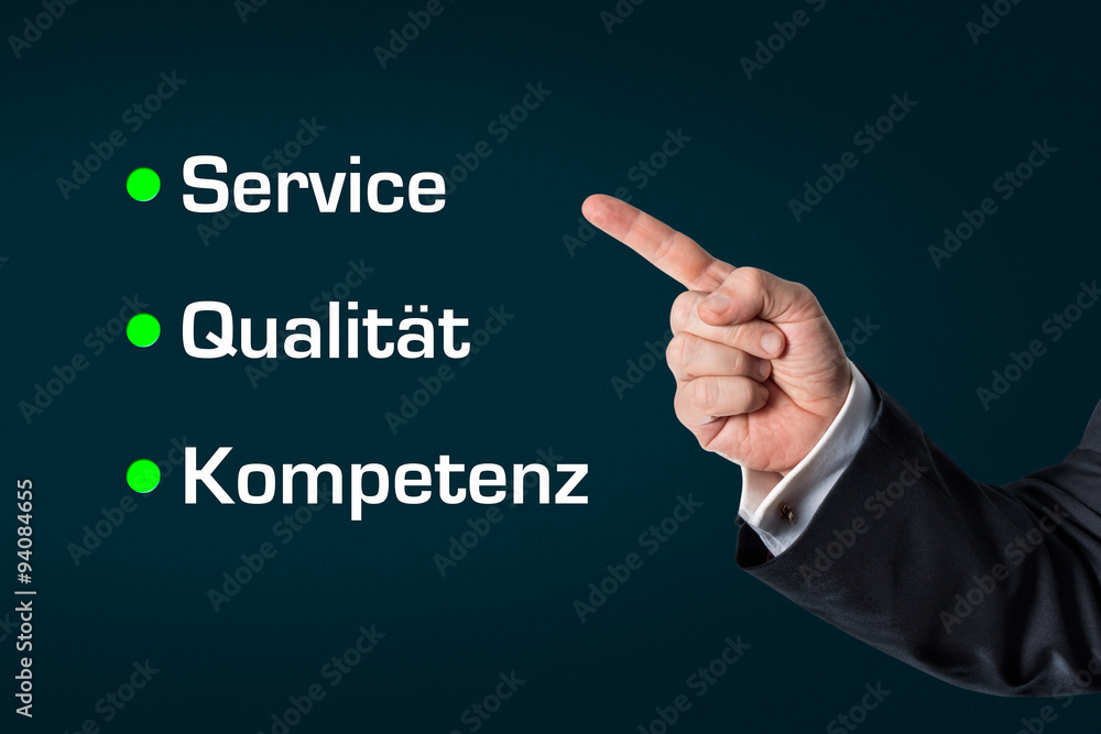 Business man pointing at the words -Service, Quality, Competence Business man pointing at the words -Service, Quality, Competence
