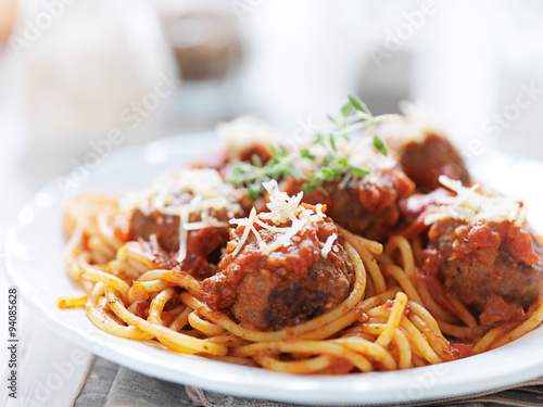 plate of italian spaghetti and meatballs with oregano garnish