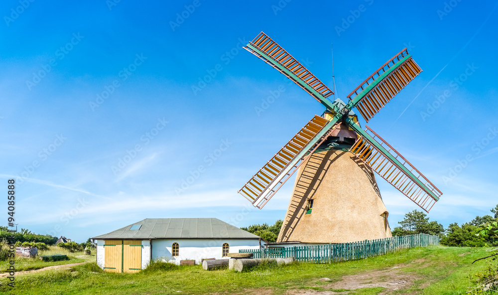Beautiful and traditional thatched windmill in german north sea village