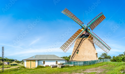 Obraz na płótnie Beautiful and traditional thatched windmill in german north sea village w salonie