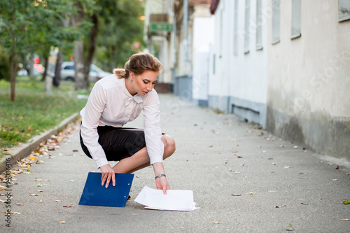 Business lawyer dropped on the street a folder with papers photo