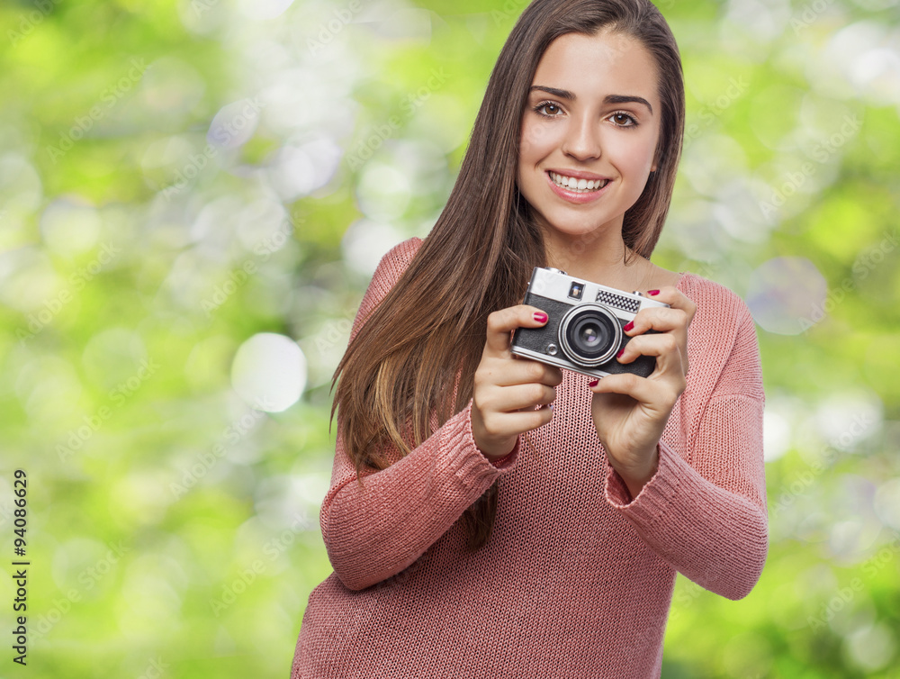 young woman holding a camera