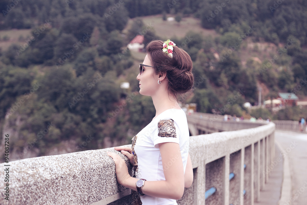 Portrait of beautiful romantic girl. Young free happy woman on bridge Portrait of beautiful romantic girl. Young free happy woman on bridge