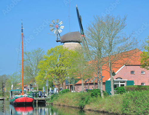 Windmühle und Fehnschiff am Fehnkanal an der Fehnroute in Ostfriesland bei Grossefehn,Niedersachsen,Deutschland  photo