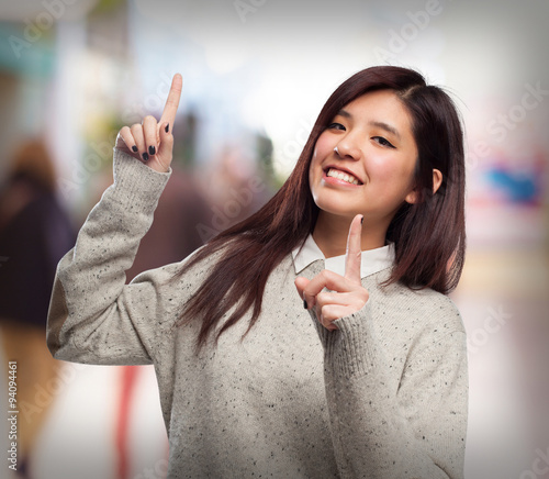 cool chinese-woman pointing up sign