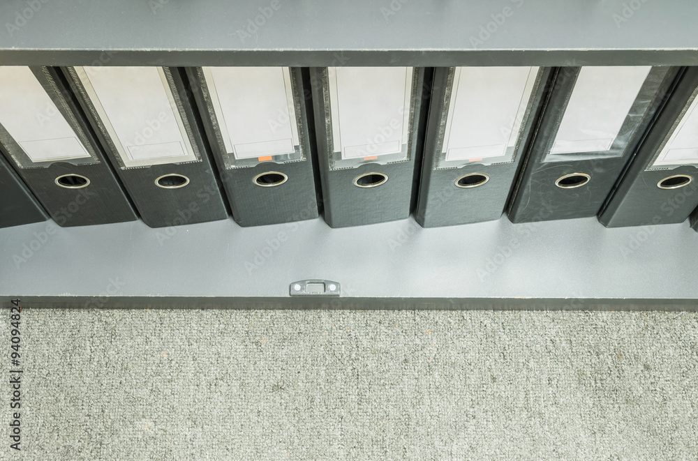 Closeup group of document file in file cabinet on gray carpet background Closeup group of document file in file cabinet on gray carpet background