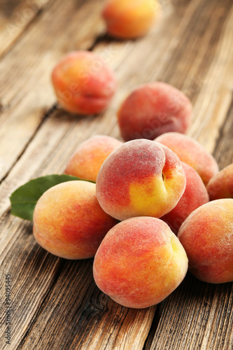 Ripe peaches fruit on a brown wooden background