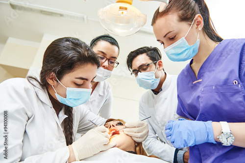 Female dentist doctor teaching students