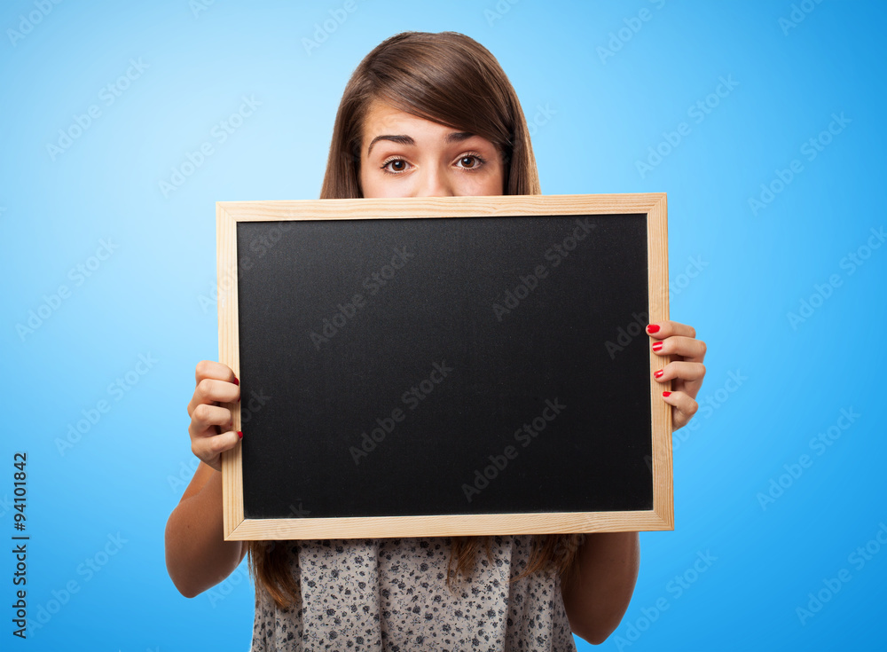 portrait of student hidden behind a chalkboard portrait of student hidden behind a chalkboard