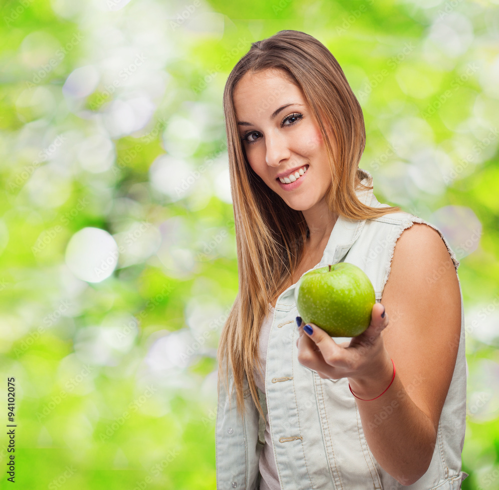 portrait of a pretty young woman offering an apple portrait of a pretty young woman offering an apple