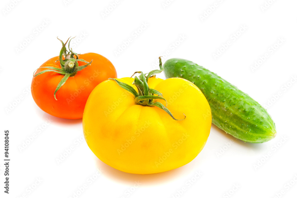 two tomatoes and cucumber on white two tomatoes and cucumber on white