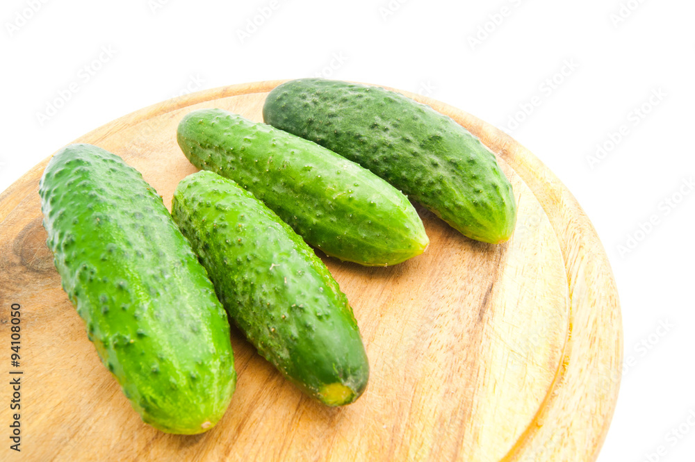 four cucumbers on cutting board four cucumbers on cutting board