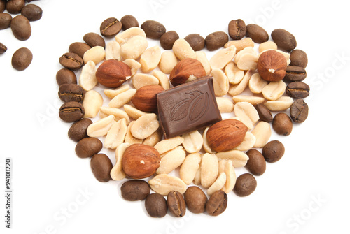 Heart of coffee beans, chocolate, peanuts and hazelnuts