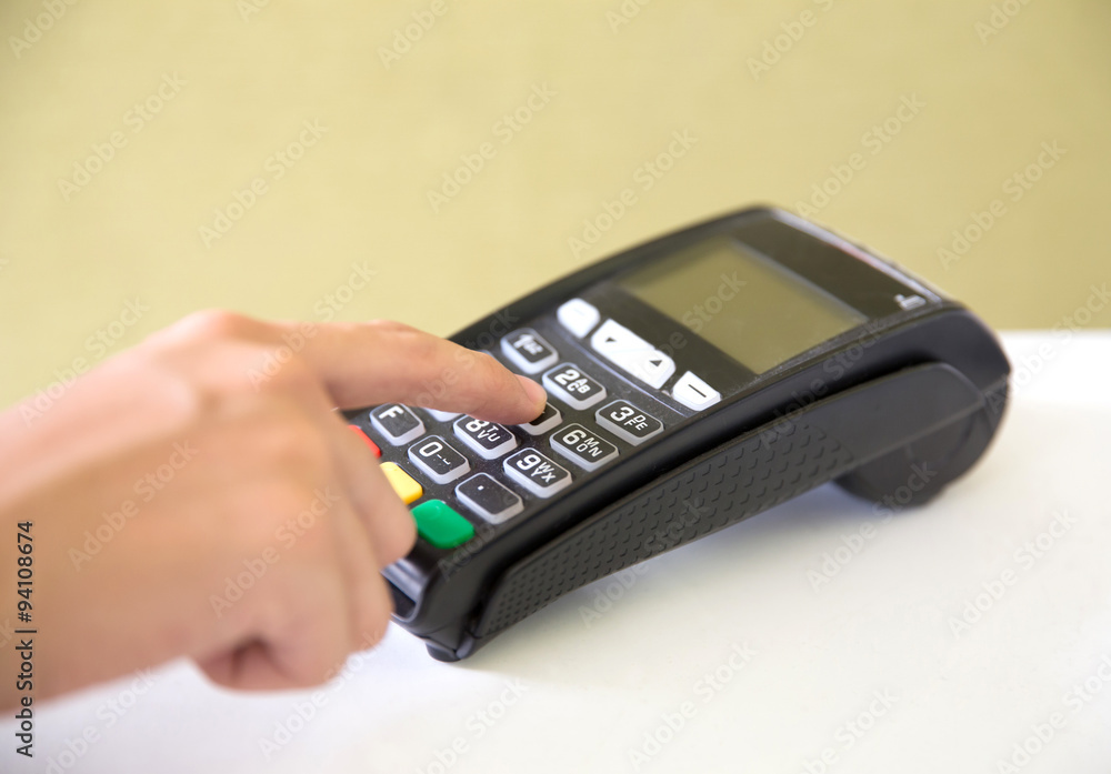 EDC ( electronic Data Capture) machine hand pressing password on EDC ( electronic Data Capture) machine hand pressing password on