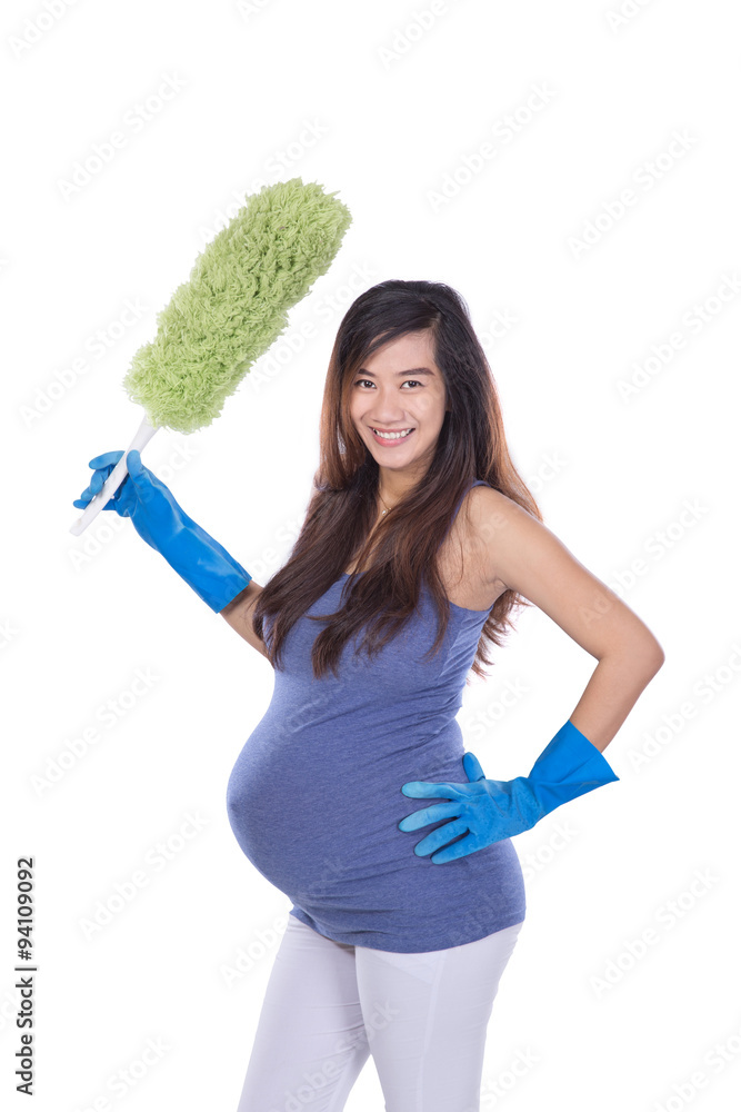 Asian pregnant woman holding a wiper while smiling on white back Asian pregnant woman holding a wiper while smiling on white back