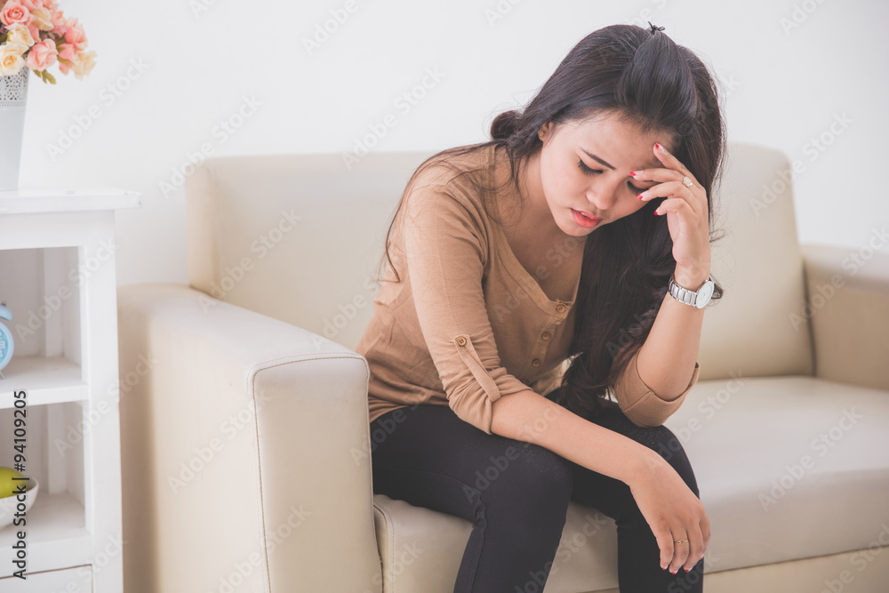 depress woman touching her fore head depress woman touching her fore head