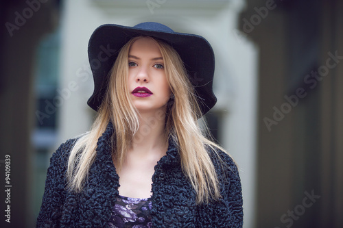 Fashionable young woman posing outside in a city street. Winter Fashion