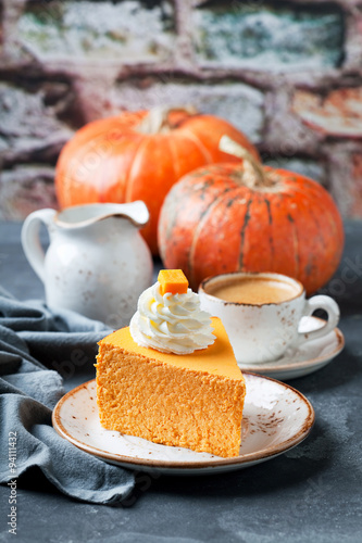 Piece of pumpkin cheesecake decorated with whipped cream, selective focus