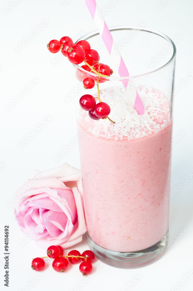 Mixed berry smoothie milkshake made from blended red berries and strawberries with yogurt. Sprinkled with coconut and served in a glass with a pink rose and isolated on a white background. Mixed berry smoothie milkshake made from blended red berries and strawberries with yogurt. Sprinkled with coconut and served in a glass with a pink rose and isolated on a white background.