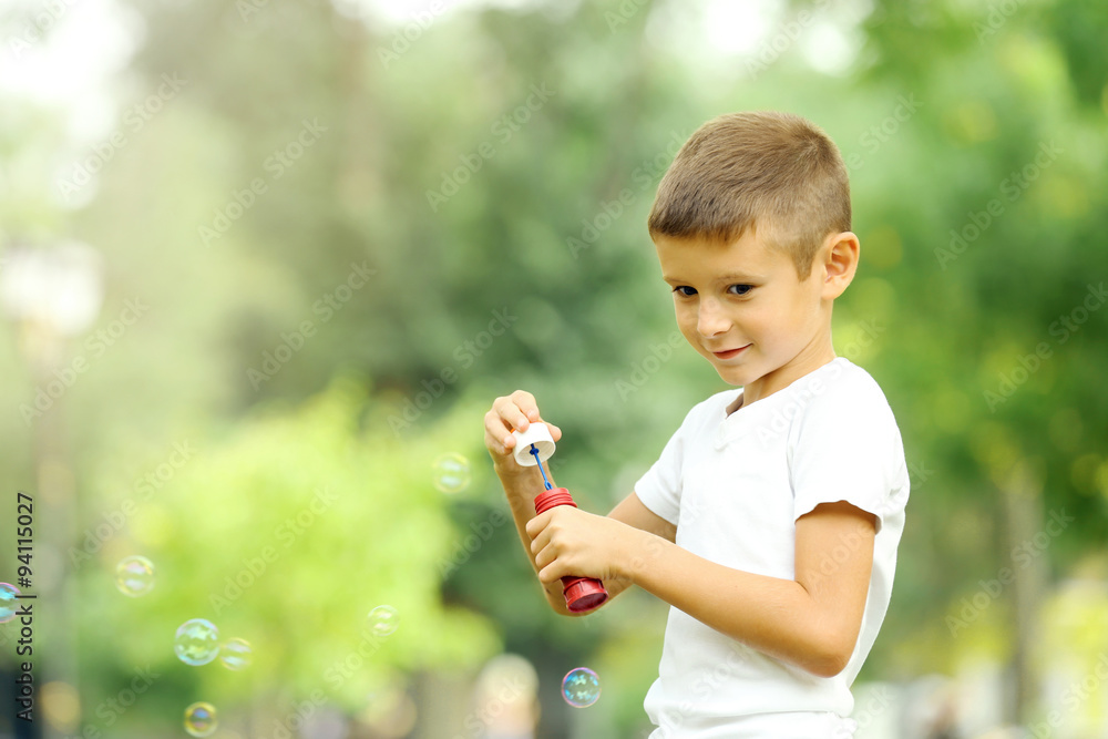 Little boy playing with bubbles in the park Little boy playing with bubbles in the park