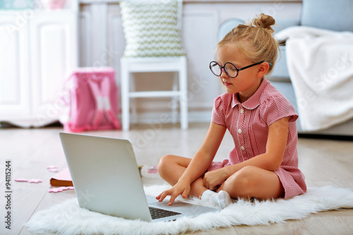Little girl with laptop in ...