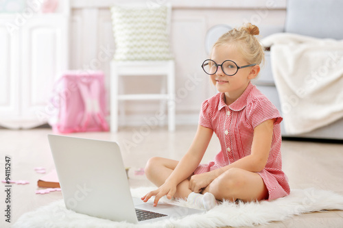 Little girl with laptop in ...