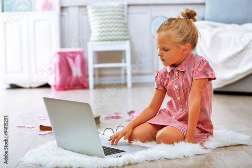Little girl with laptop in ...