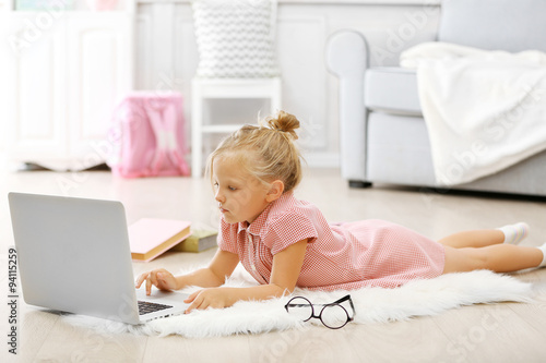 Little girl with laptop in ...