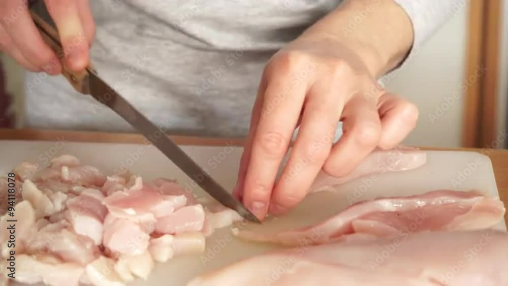 Female hands cutting raw chicken meat 4K Female hands cutting raw chicken meat 4K