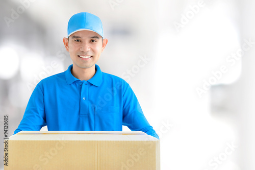 Deliveryman giving a cardboard parcel box