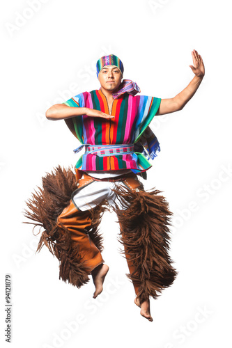 Ecuadorian dancer showcasing Andean culture in traditional attire,performing a dynamic jump with llama or alpaca pants,captured in a studio setting against a white background.