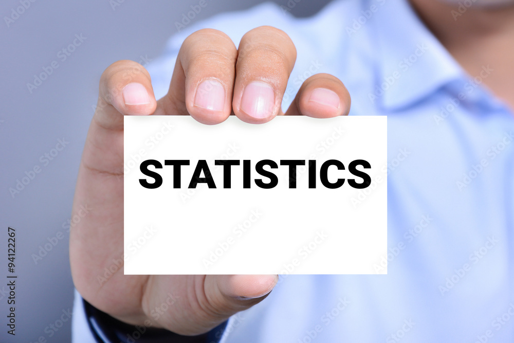 STATISTICS word on the card held by a man hand STATISTICS word on the card held by a man hand