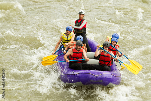 A family team conquers extreme whitewater rapids in Ecuador on a thrilling rafting adventure. The water is wild and white as they navigate the challenging course.