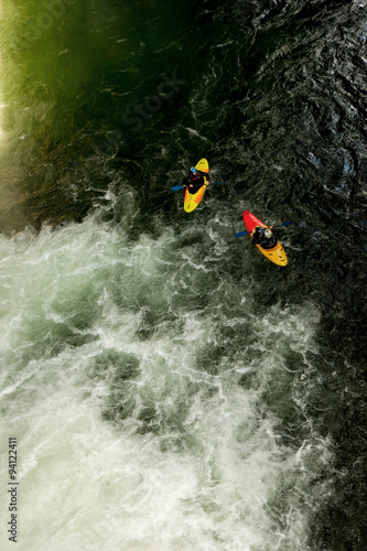 Experience the thrill of a waterfall pool as you join a dynamic duo of kayakers on their exhilarating adventure.
