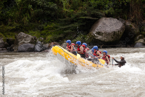 A team of adventurers navigate a white-water river in Ecuador on a raft, braving dangerous rapids for an extreme and risky challenge. © Ammit
