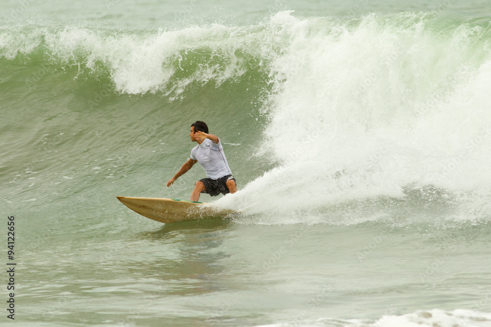 Experienced surfer eagerly readies to conquer the mighty wave,fueled by passion and determination. Experienced surfer eagerly readies to conquer the mighty wave,fueled by passion and determination.