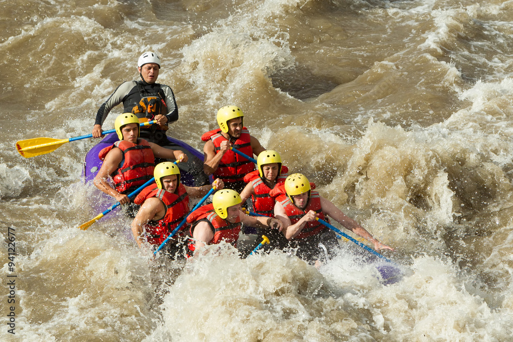 A thrilling rafting adventure in Ecuador's white water river, guided through rocky terrain, offering an unforgettable tourism experience.
