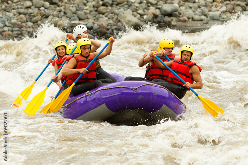 A team of adventurers navigating thrilling whitewater rapids on a white raft, conquering the wild river with excitement and skill.