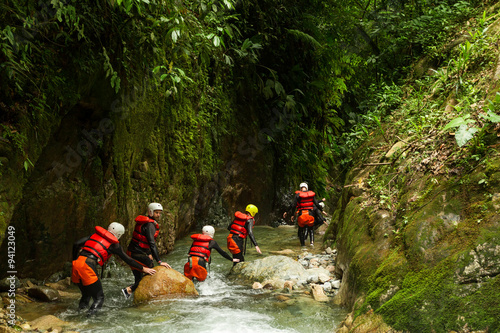A group of adventurous people exploring the dangerous canyons of Ecuador's Llanganates, engaging in thrilling canyoning activities.