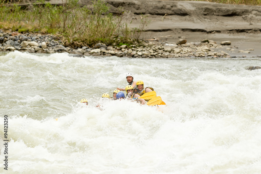 A diverse group of male and female tourists accompanied by a skilled guide embarking on a thrilling whitewater river rafting adventure in Ecuador