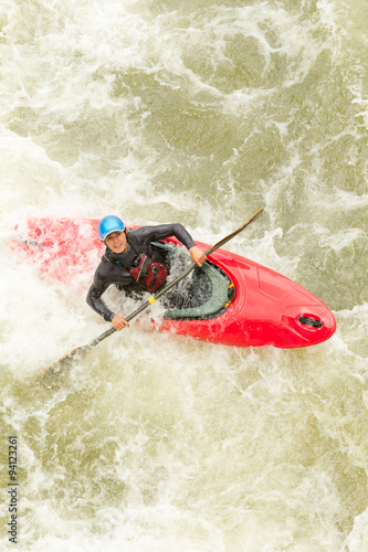 Experienced kayaker navigating challenging whitewater rapids with skill and precision.
