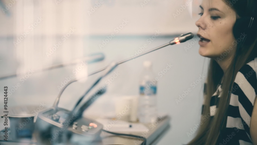 woman translator working in a conference room, a lot of work on woman translator working in a conference room, a lot of work on