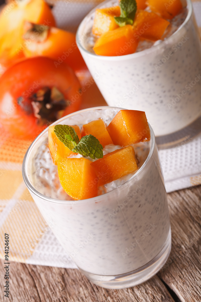 Healthy Food: dessert with chia seeds and persimmon close up. vertical
Healthy Food: dessert with chia seeds and persimmon close up. vertical