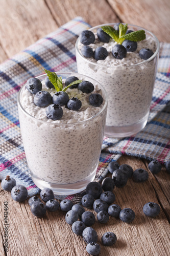 Delicious pudding with chia seeds and blueberries close-up. vertical 